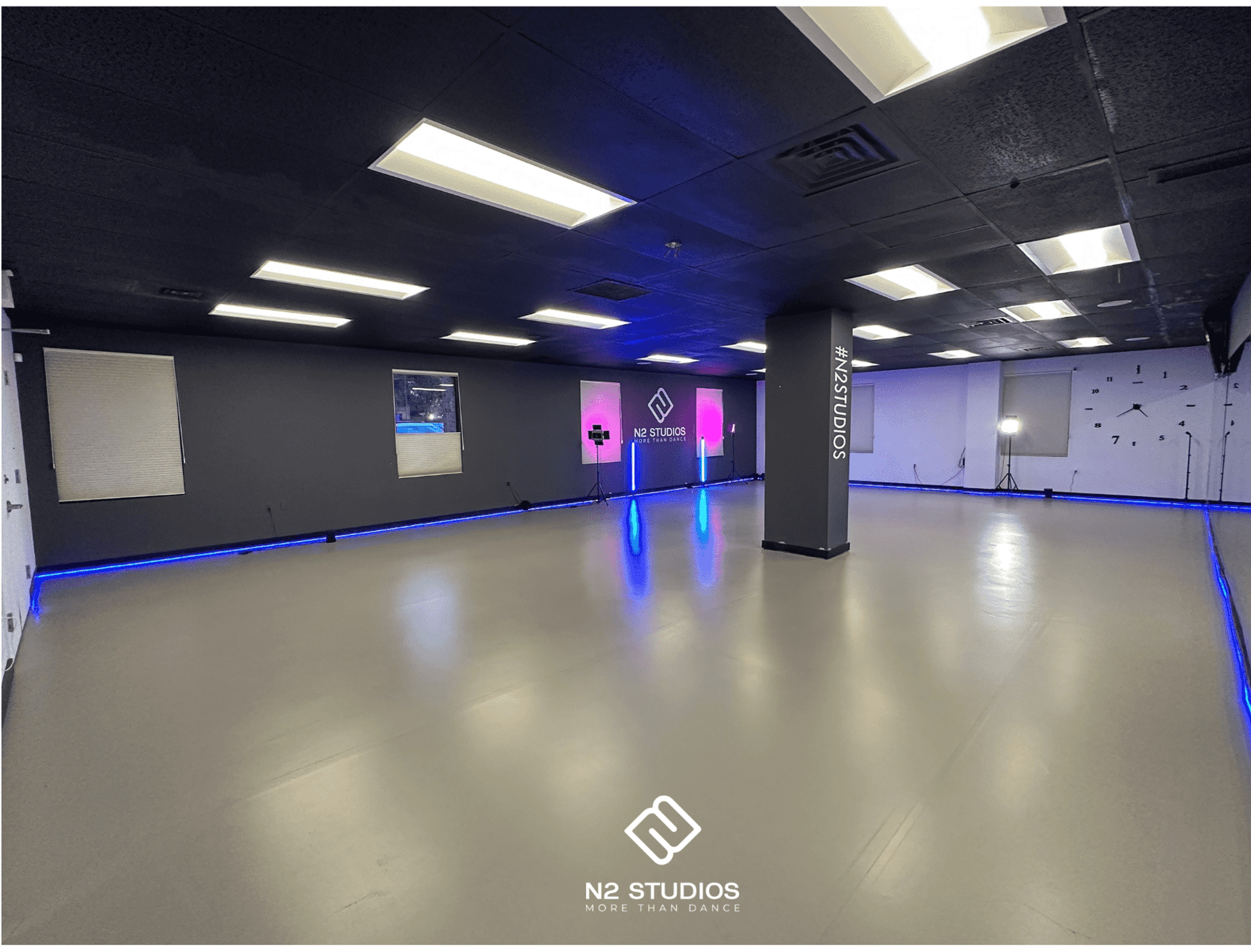 An empty N2 dance studio with its logo wall and blue floor lighting, shown on N2’s original rental page.