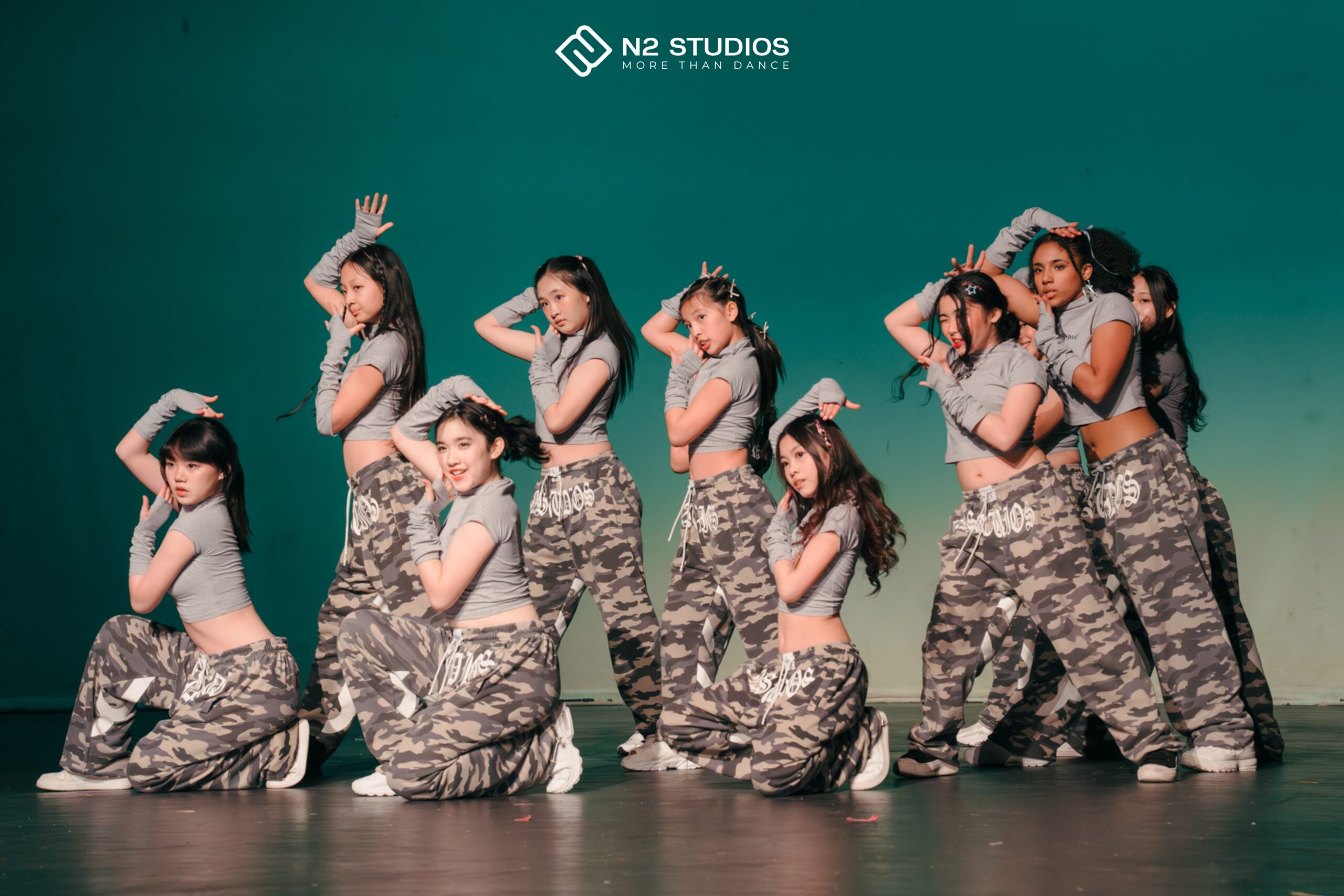 N2 Youth dancers posing together in matching N2 camouflage pants.