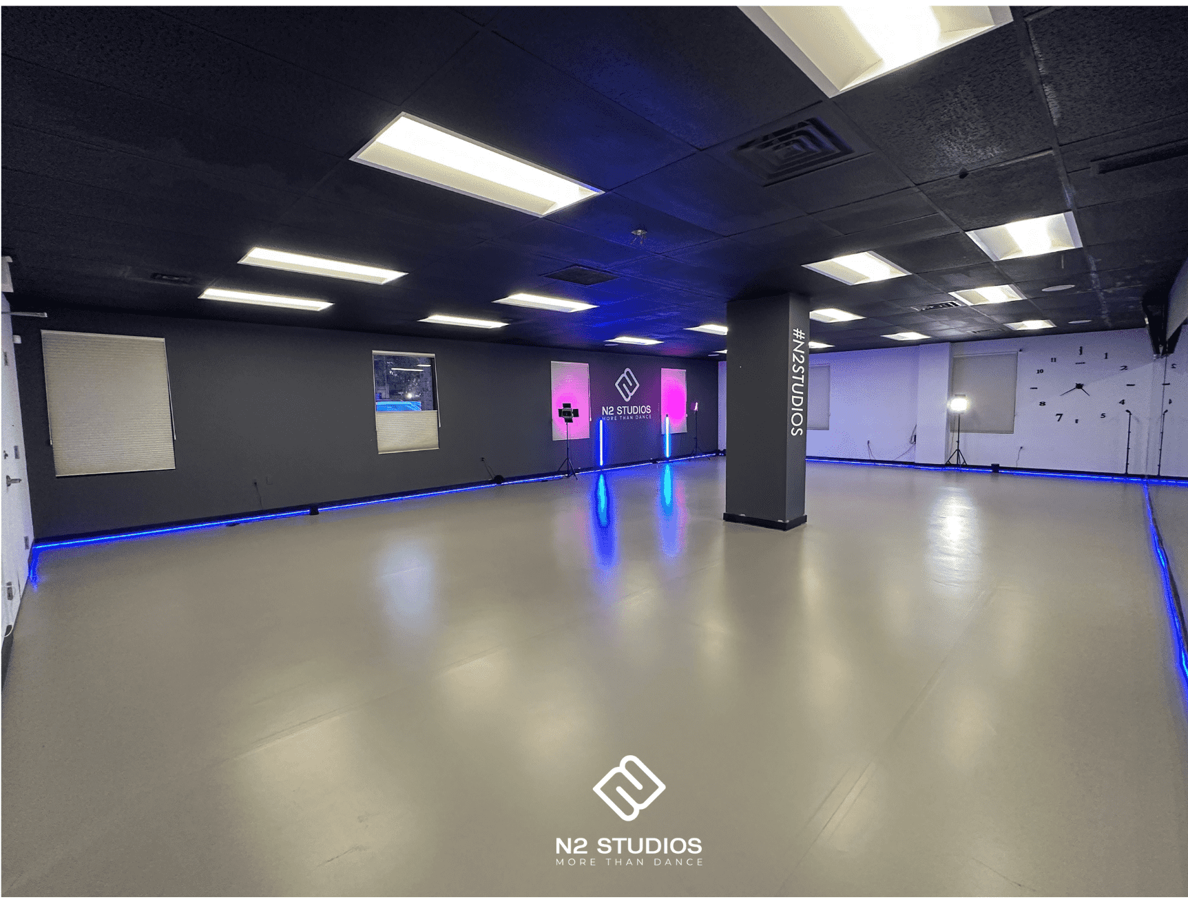 An empty N2 dance studio with its logo wall and blue floor lighting, shown on N2’s original rental page.