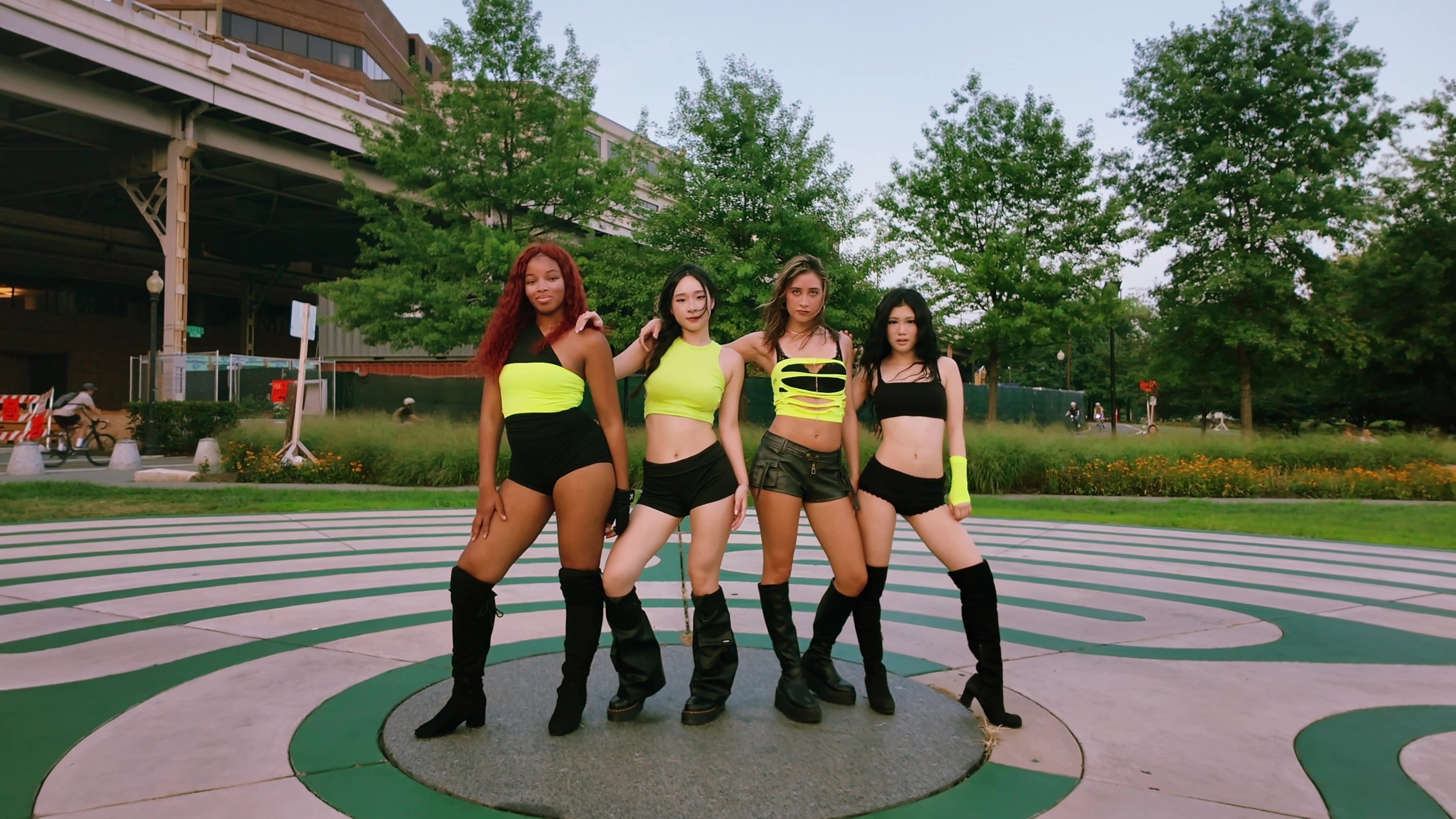 Four N2DC dancers in coordinated lime and black outfits holding their final group pose.